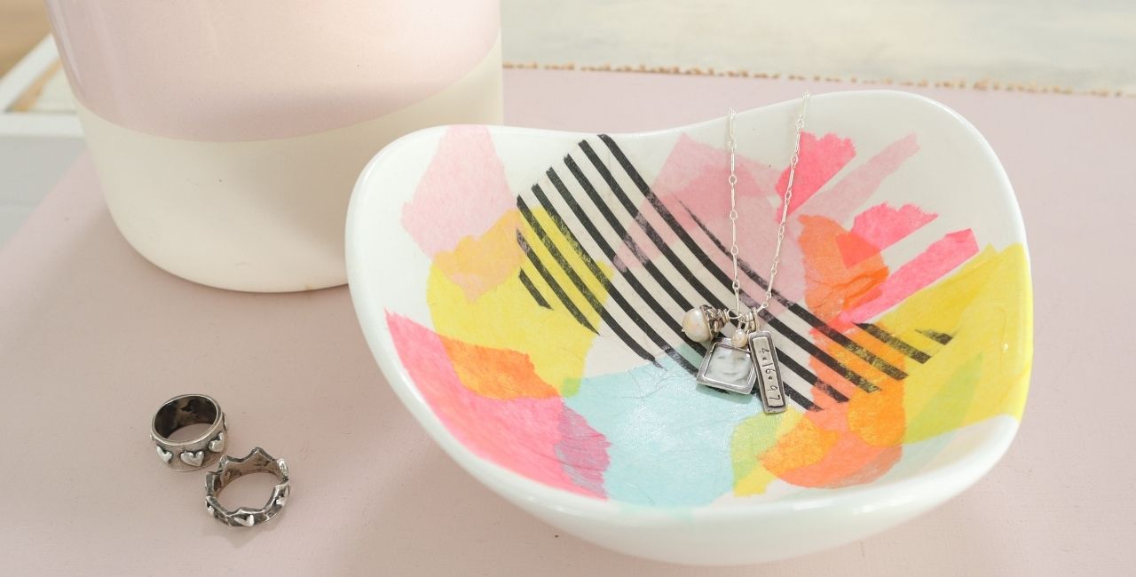 this is a photo of a white jewelry dish decoupaged with colorful tissue paper